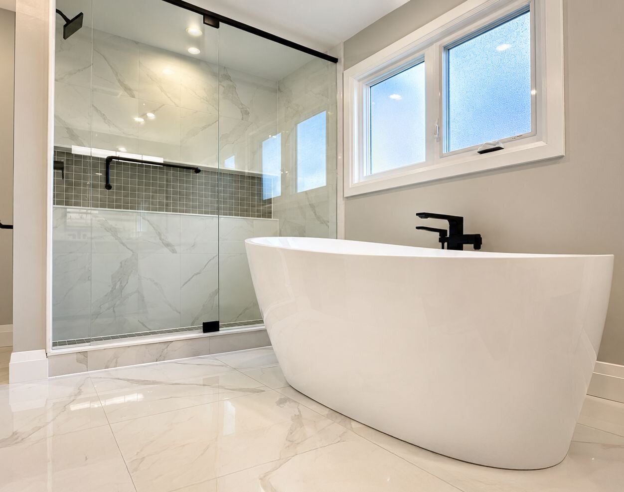 Finished bathroom with a freestanding soaker tub and a glass walk-in shower