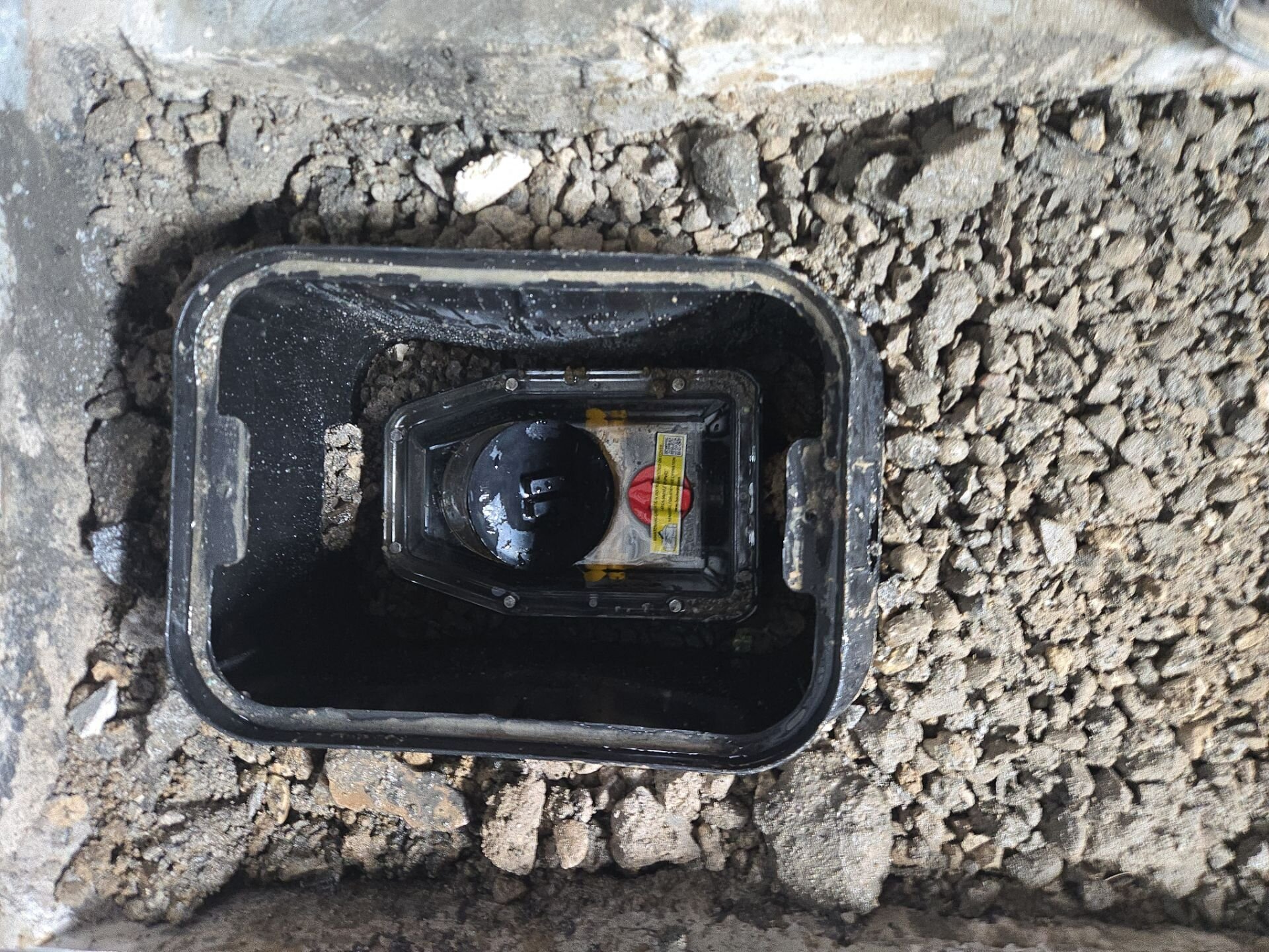 Backwater valve install, step 2 | Basement flood protection, Kitchener-Waterloo Backwater valve inside its access box, ready for the floor to be closed, Einwechter Plumbing & Heating, Kitchener-Waterloo