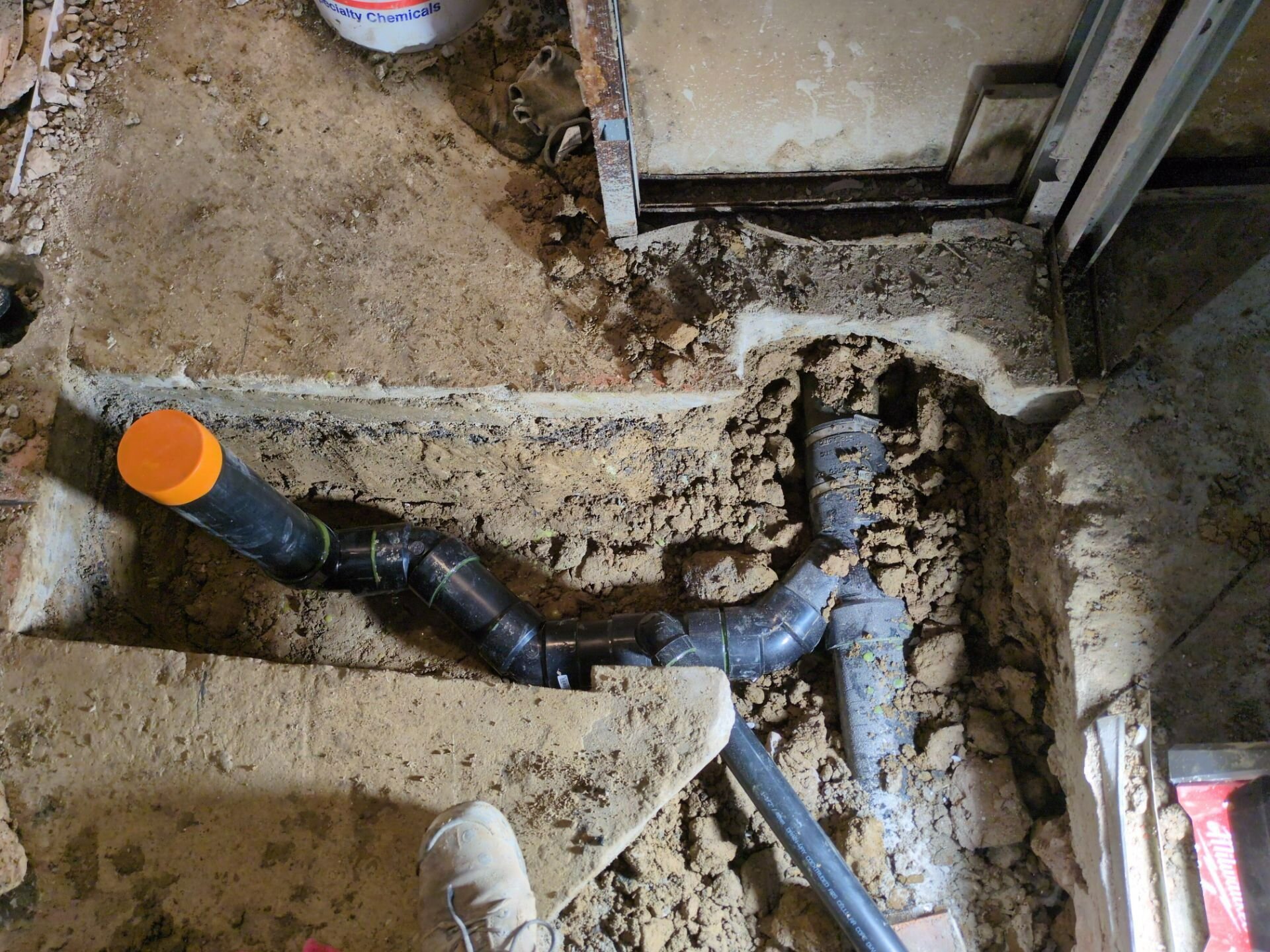 New drain lines laid in a basement trench – sewer and water line replacement, Einwechter Plumbing & Heating, Kitchener-Waterloo