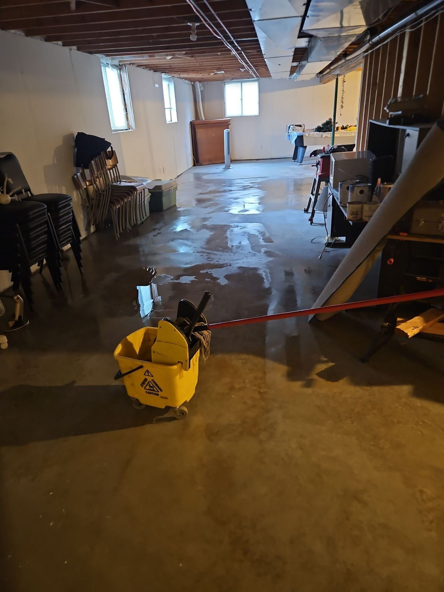 Flooded basement floor | Basement flood protection, Kitchener-Waterloo Water across an unfinished basement floor after a flood in a home in Waterloo Region, Einwechter Plumbing & Heating, Kitchener-Waterloo