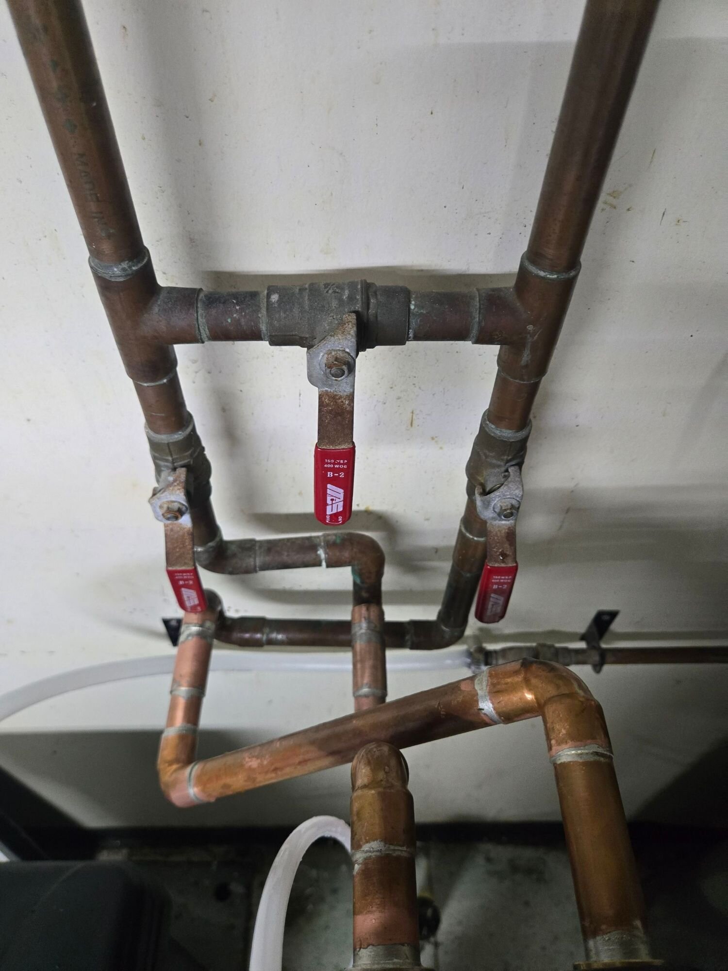 New copper manifold with shutoff valves installed in a basement | Pipe repair and repiping, Kitchener-Waterloo New copper manifold with shutoff valves installed in a basement – pipe repair and repiping, Einwechter Plumbing & Heating, Kitchener-Waterloo