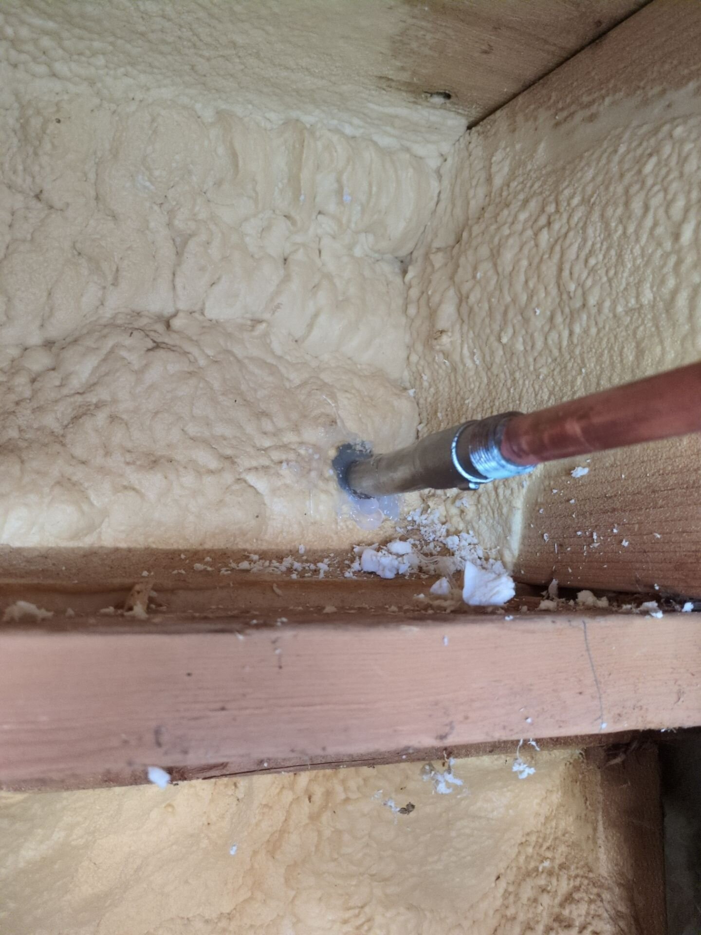 Frost-free outside tap installed by Einwechter Plumbing & Heating, with the copper supply run through the spray-foamed rim joist so the valve sits inside the warm wall, Kitchener-Waterloo