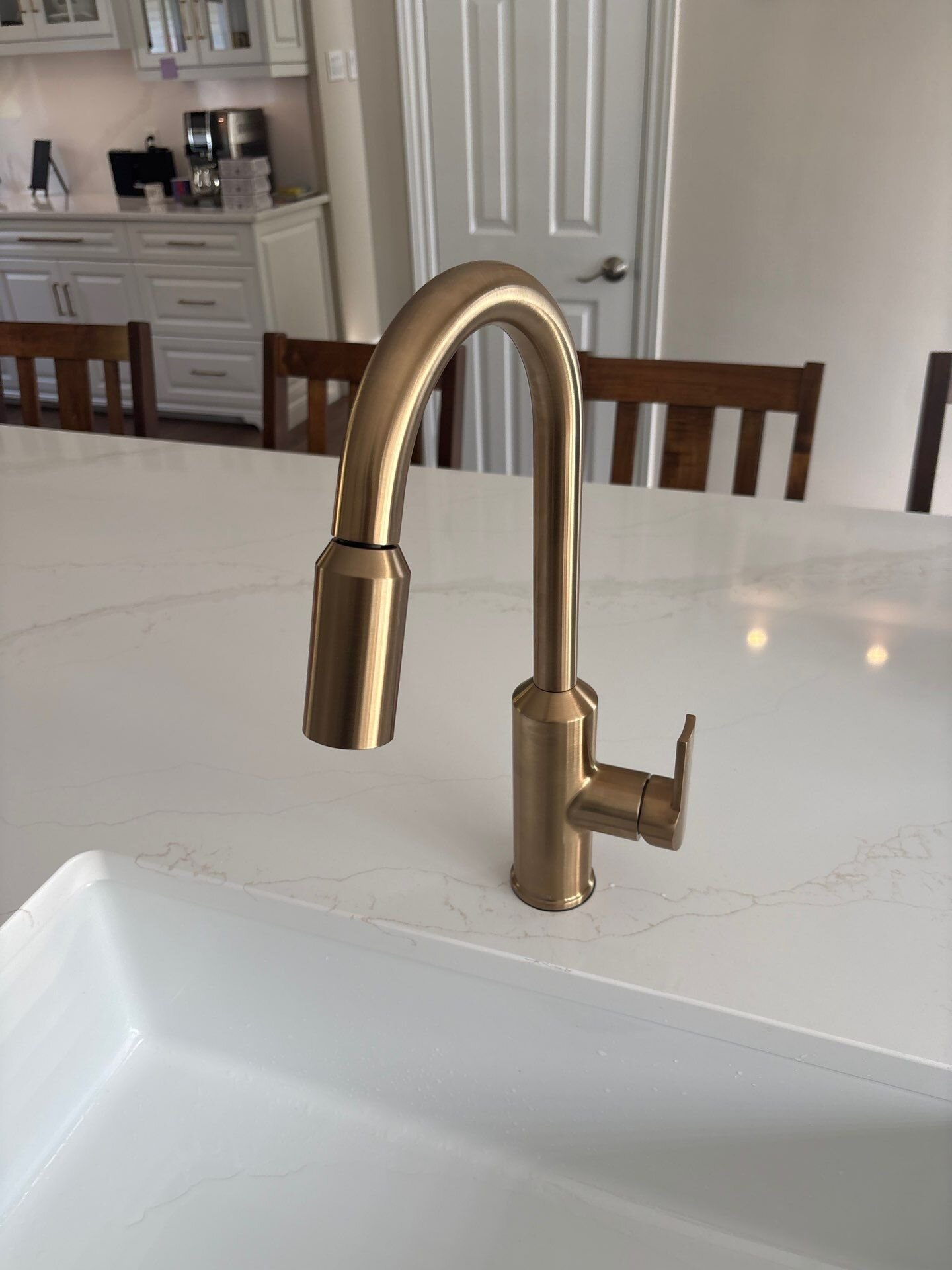 Gold pull-down kitchen faucet installed | Faucet installation, Kitchener-Waterloo Brushed gold pull-down kitchen faucet installed on a quartz island by Einwechter Plumbing & Heating, Kitchener-Waterloo