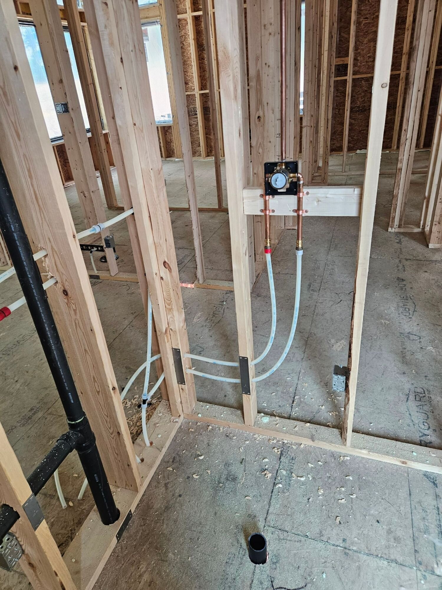 PEX and ABS rough-in in new-home framing | New home plumbing, Kitchener-Waterloo PEX water lines and ABS drain stack roughed in through the framing of a new home, with the shower valve set – new home plumbing, Einwechter Plumbing & Heating, Kitchener-Waterloo