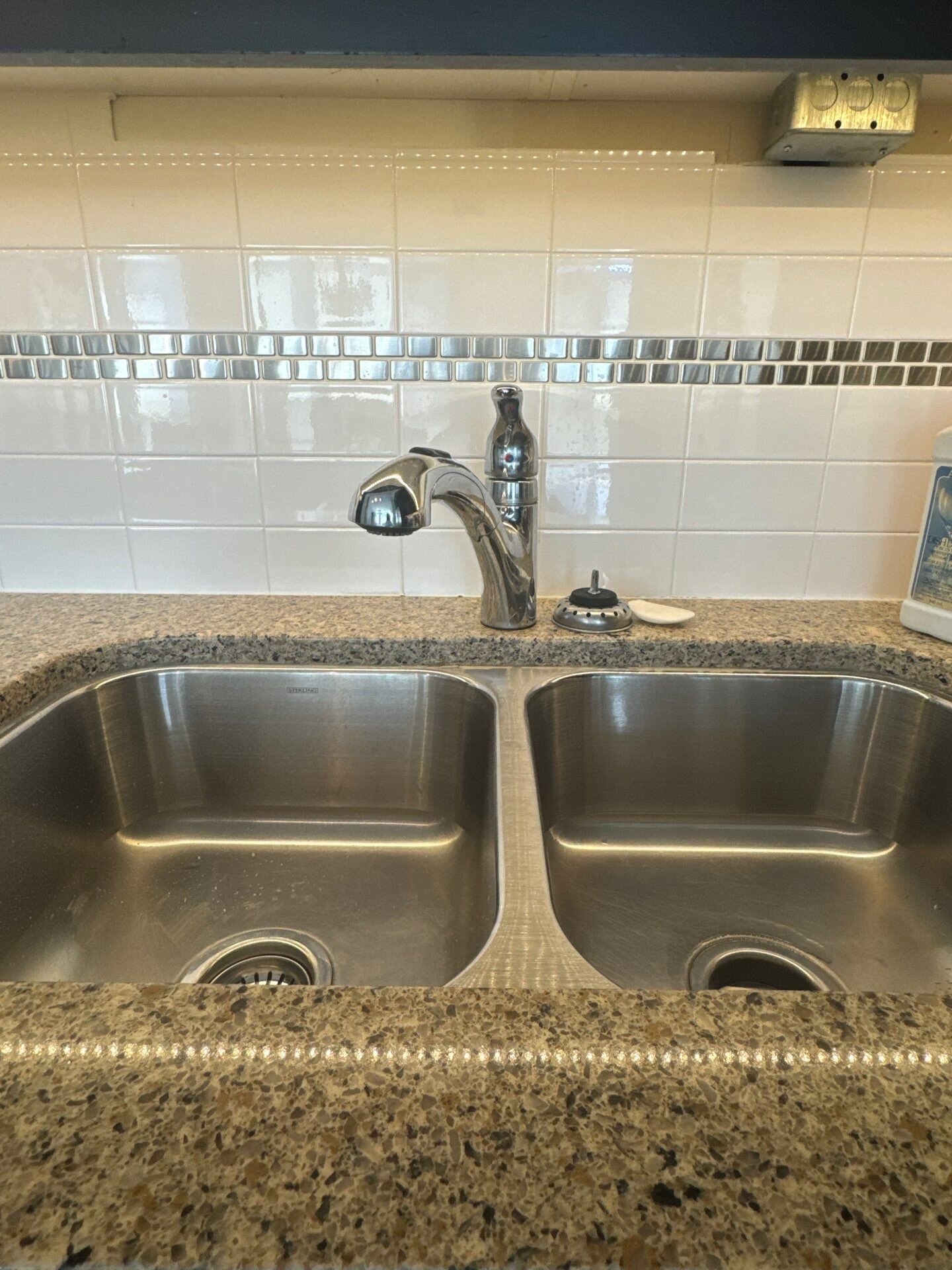 Pull-out kitchen faucet installed over a double stainless sink with granite coun | Faucet and sink installation, Kitchener-Waterloo Pull-out kitchen faucet installed over a double stainless sink with granite counter – faucet and sink installation, Einwechter Plumbing & Heating, Kitchener-Waterloo