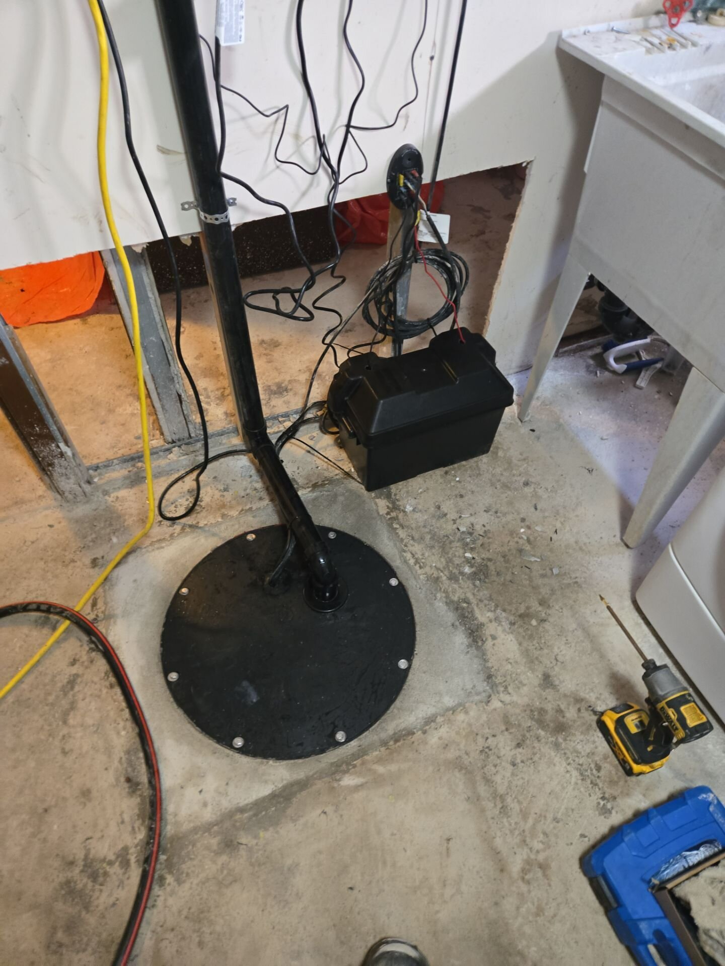 Sump pump with battery backup installed | Sump pump replacement, Kitchener-Waterloo Finished sump pump install with sealed basin lid and battery backup box in a basement, Einwechter Plumbing & Heating, Kitchener-Waterloo