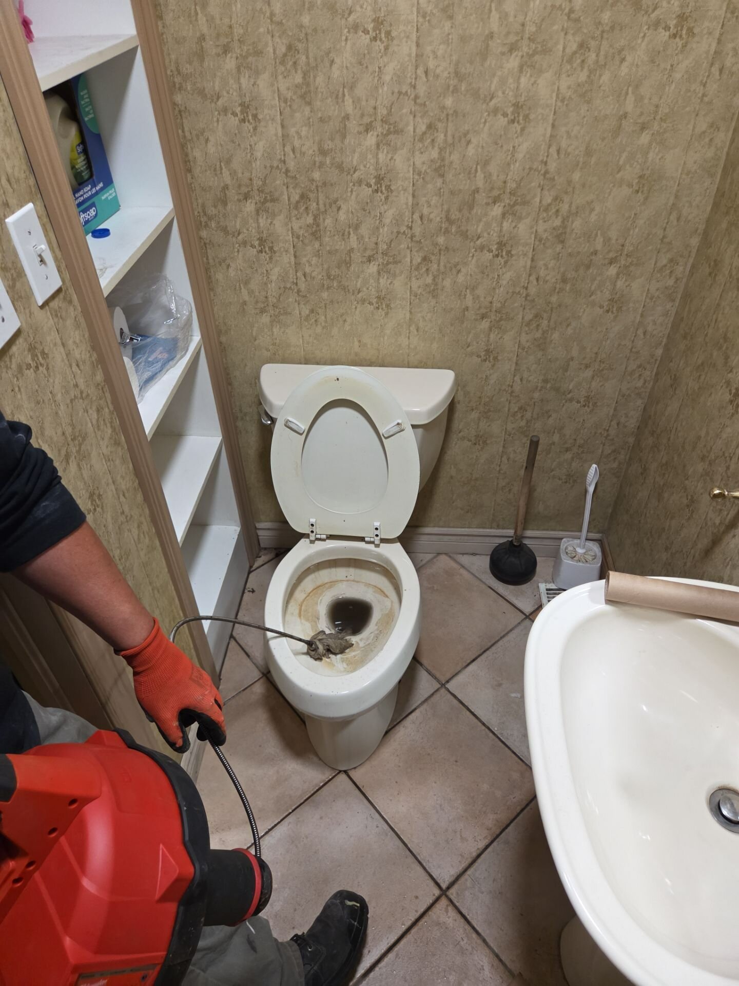 Einwechter plumber clearing a toilet with a drain auger | Drain cleaning and hydro jetting, Kitchener-Waterloo Einwechter plumber clearing a toilet with a drain auger, Kitchener-Waterloo